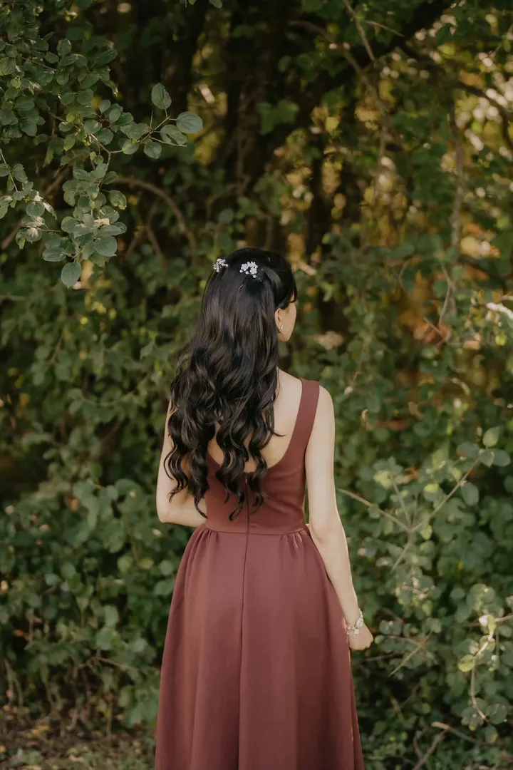 Bridesmaid hairstyle with long soft curls and floral pins by Arsh Sandhu Allure – GTA, Ontario