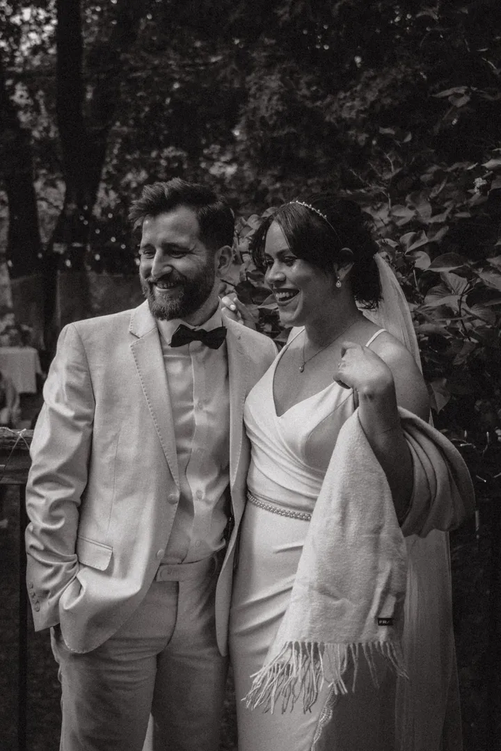 Newlyweds laughing outdoors, bridal updo and makeup by Arsh Sandhu Allure – GTA, Ontario